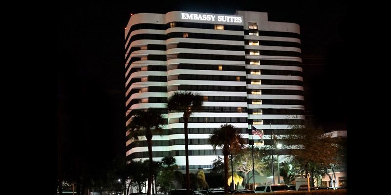 The embassy suites building is lit up at night