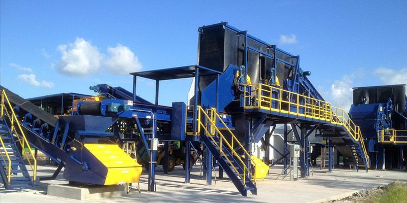 A large blue and yellow machine with stairs leading up to it.