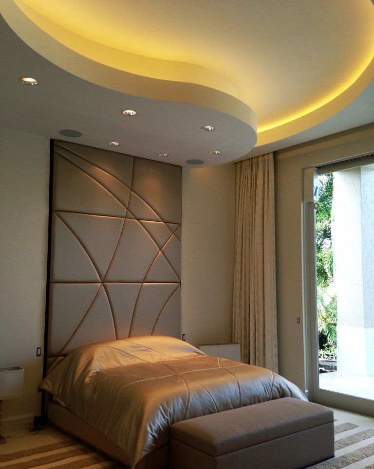 A bedroom with a large bed and a sliding glass door