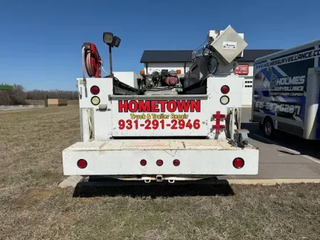 A white hometown truck is parked in a parking lot