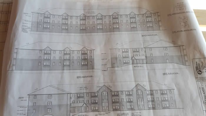 A black and white drawing of a building on a piece of paper.