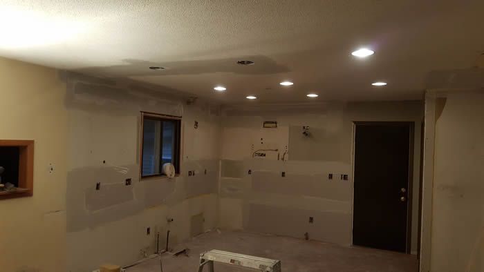 A room with a window and a door is being remodeled.