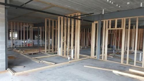 The inside of a building under construction with wooden frames.
