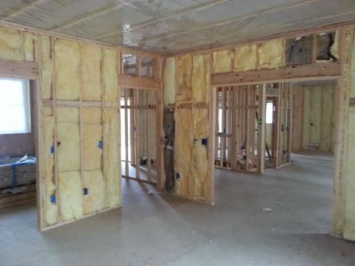 A room in a house that is being built with insulation on the walls.