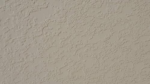 A close up of a white wall with a texture.