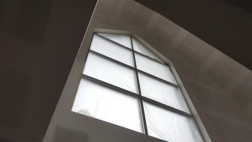 Looking up at a window in a dark room