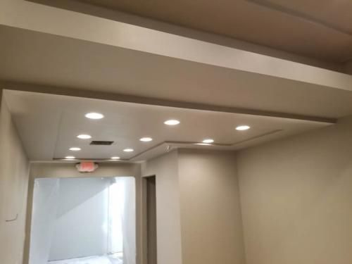 A hallway with a ceiling that has a lot of lights on it.