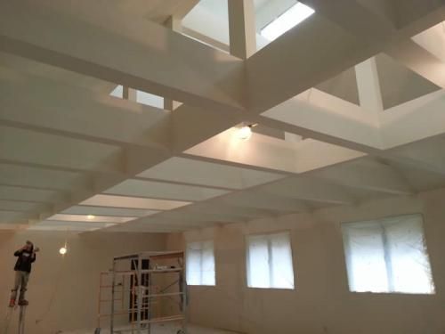 A room with a lot of windows and a white ceiling