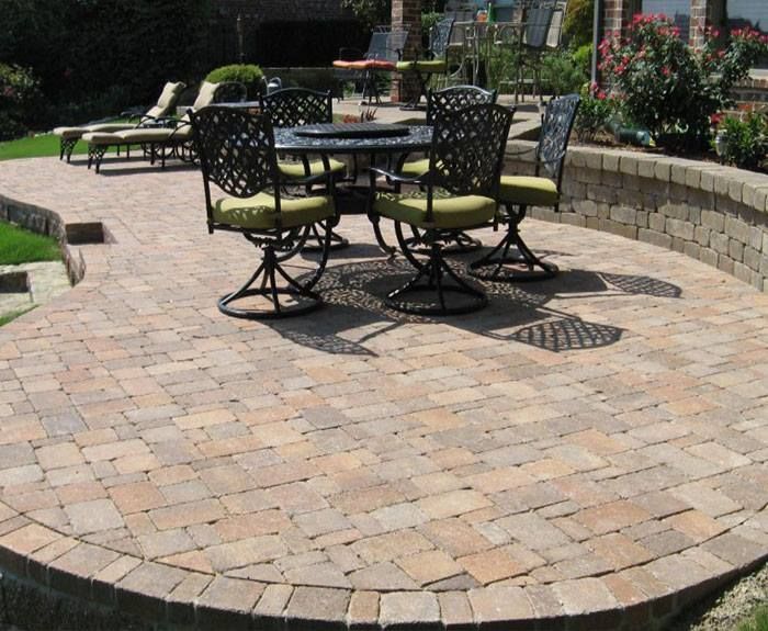 A patio with a table and chairs on it