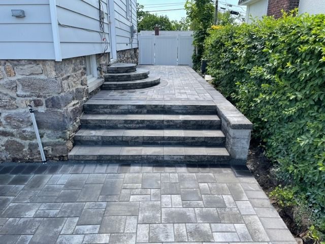 A stone walkway with stairs leading up to a house.