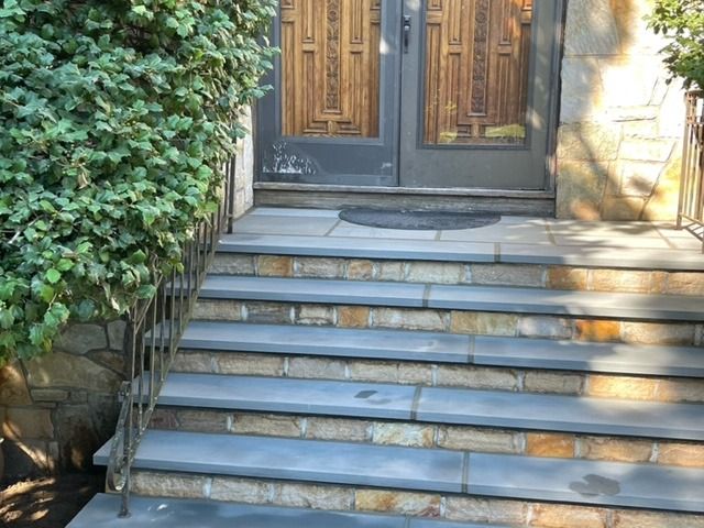 A set of stone steps leading up to a door