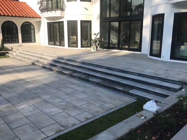 A large white house with stairs leading up to it