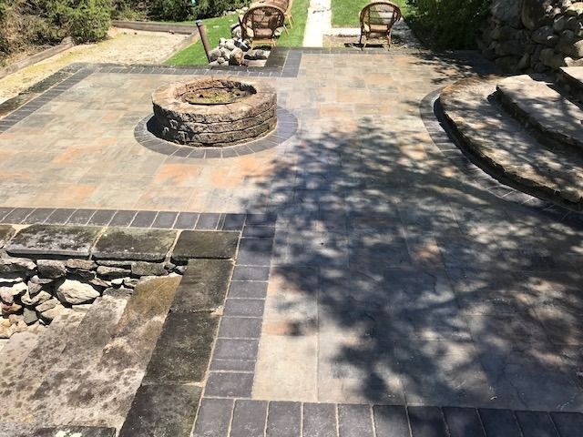 There is a fire pit in the middle of the patio.