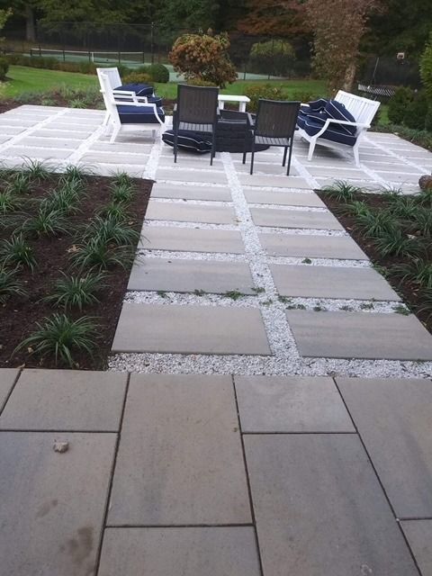 A patio with a table and chairs on it