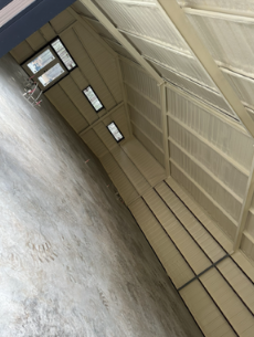 A close up of a wooden structure with foam on the ceiling.