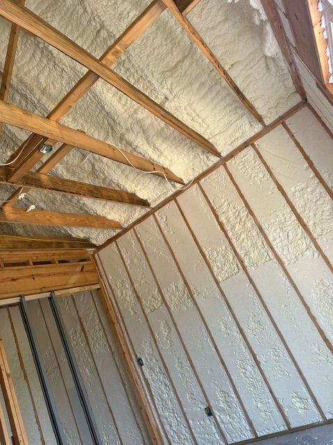 A room in a house under construction with foam insulation on the walls.