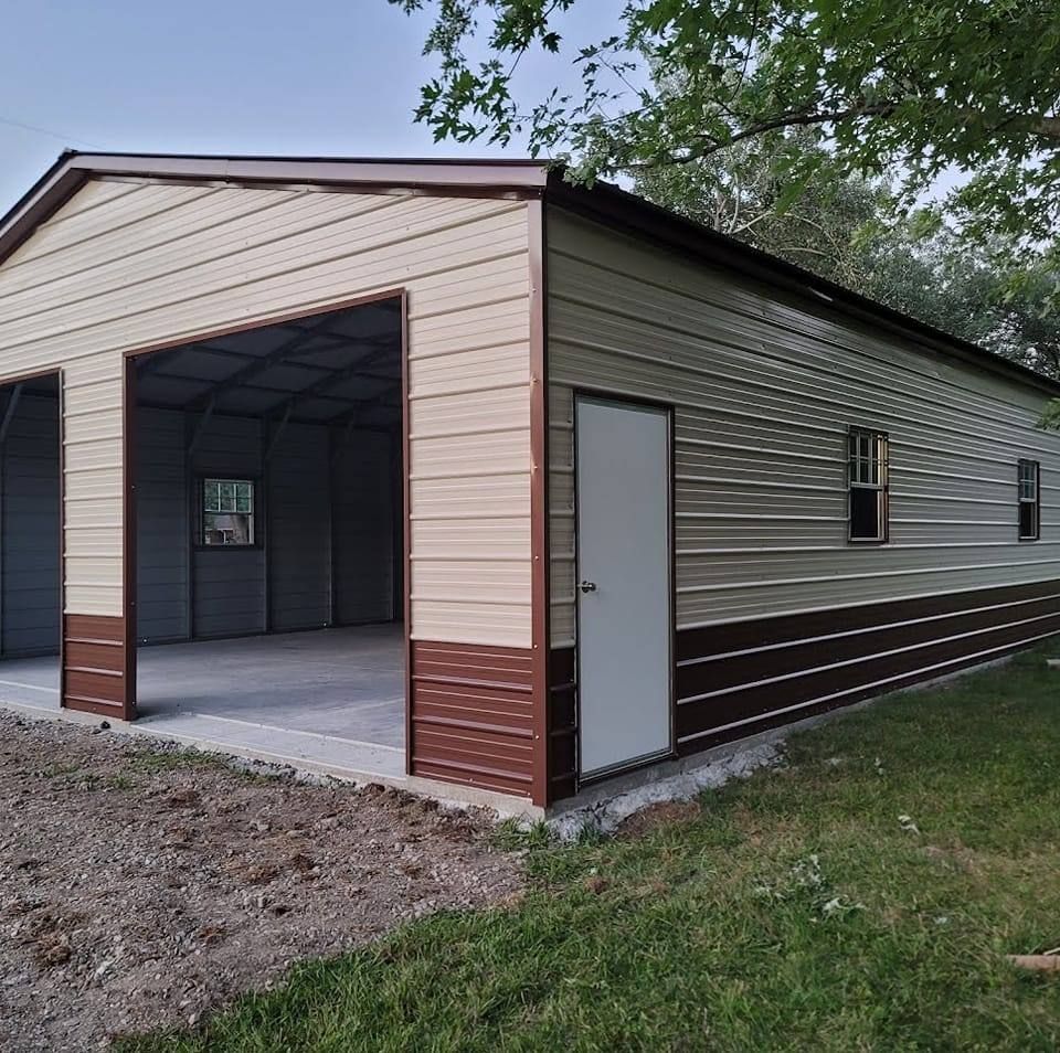 Tan and brown metal garage with two bays, a door, and two windows.