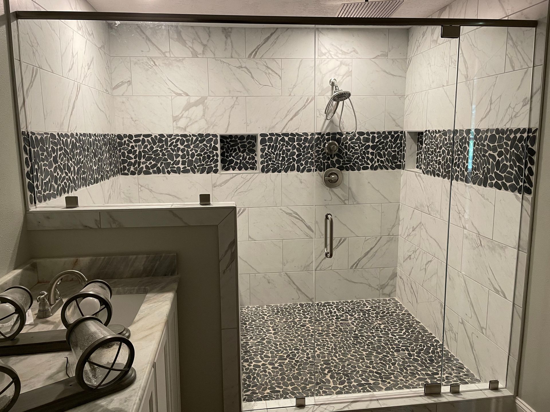 A bathroom with a walk in shower and a bathtub.