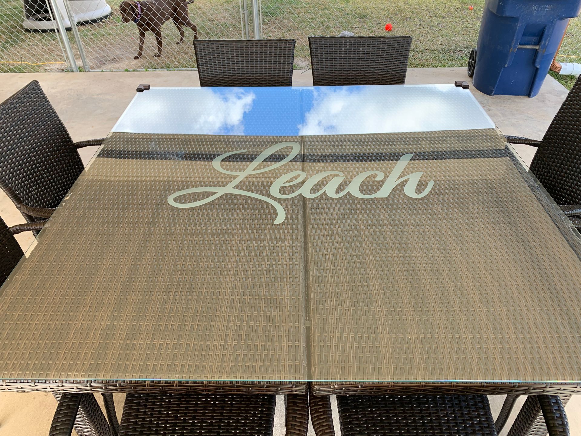 A patio table with the word reach written on it