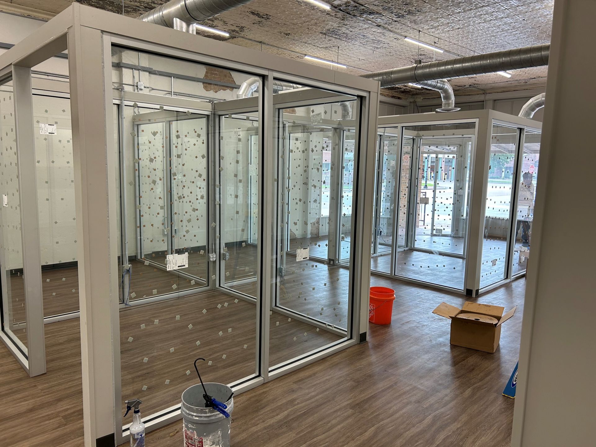 A room with a lot of windows and a box on the floor.