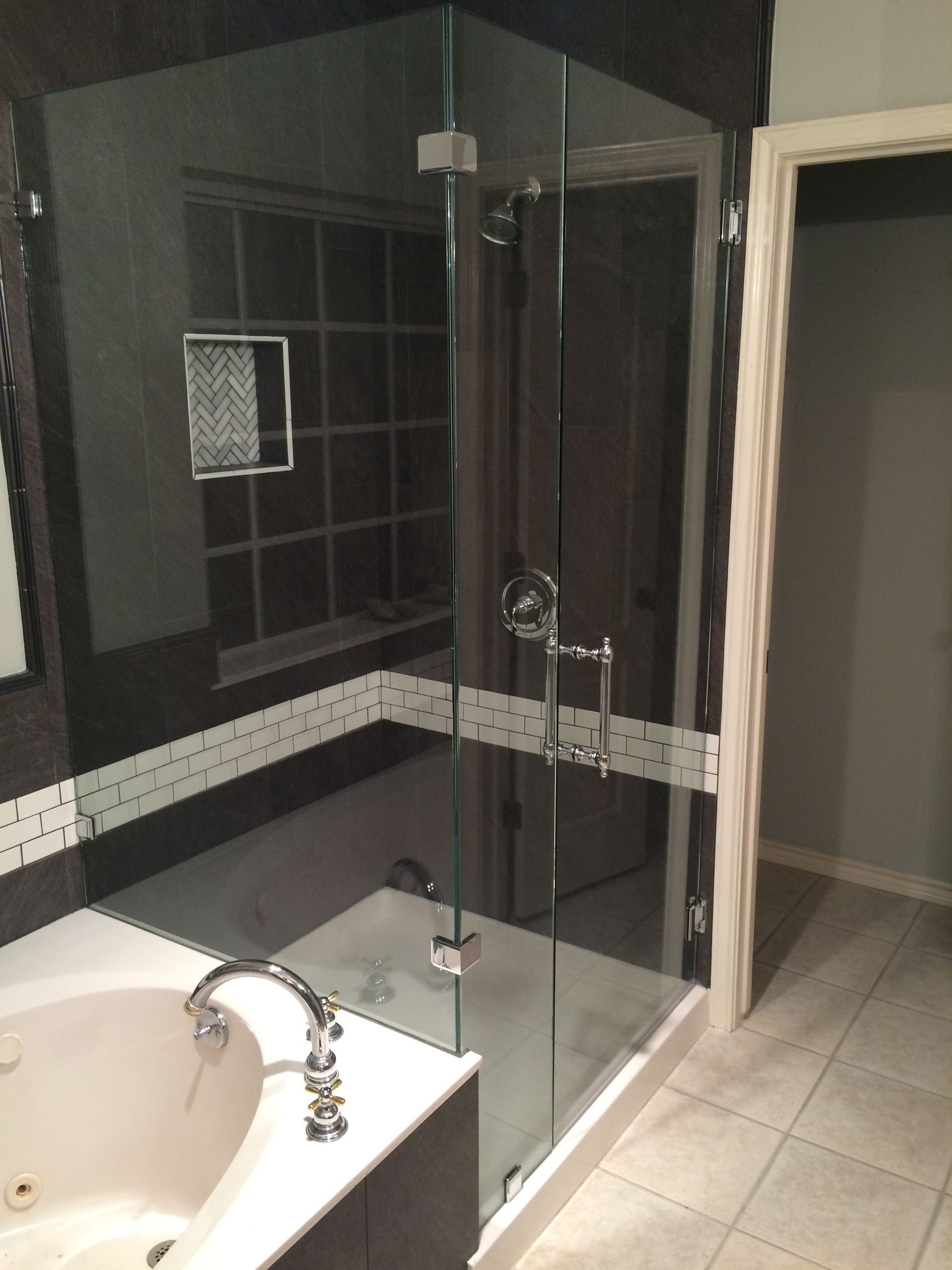 A bathroom with a tub and a walk in shower