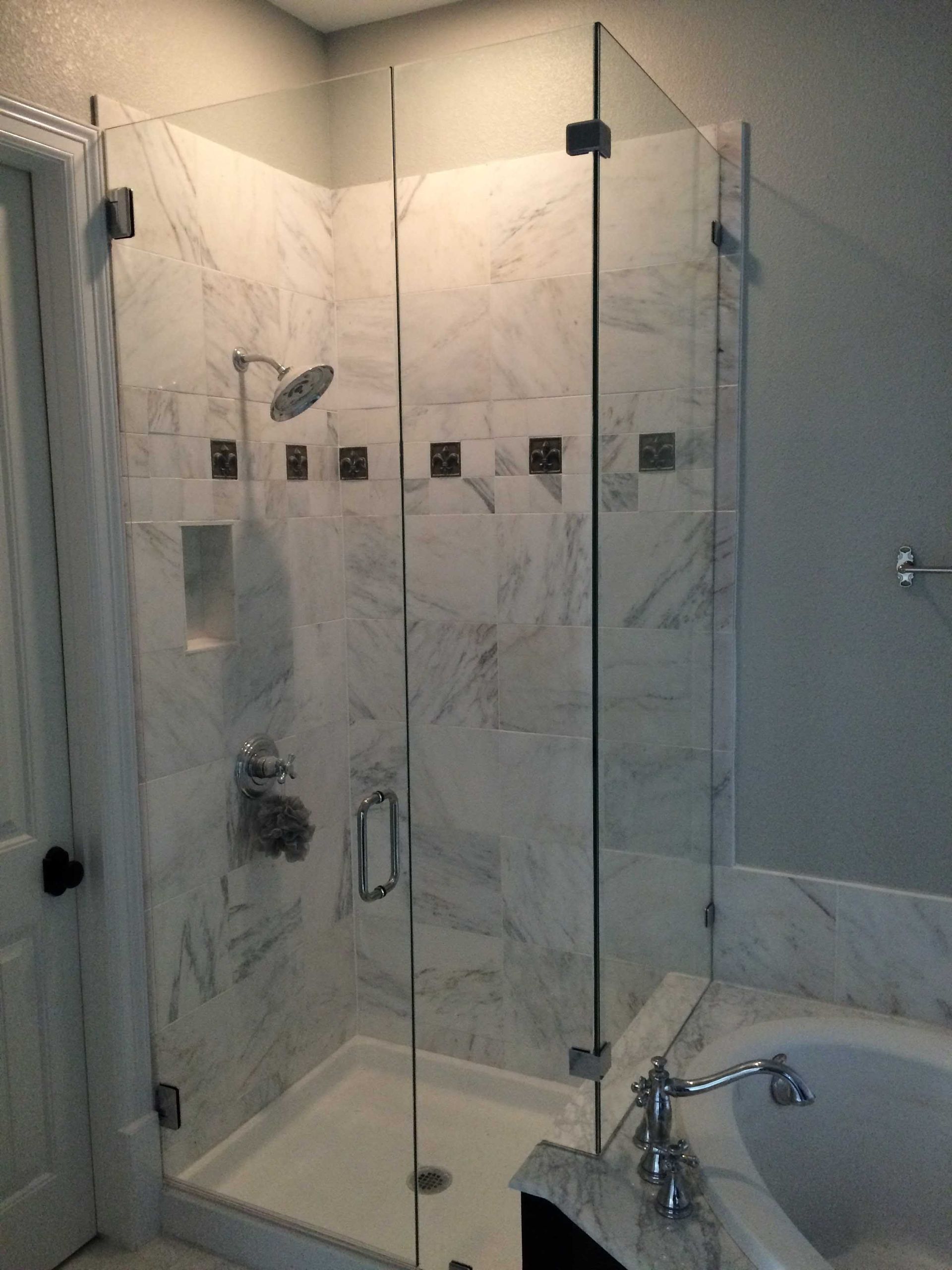 A bathroom with a walk in shower and a bathtub
