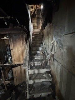 Stairs showing significant signs of fire damage
