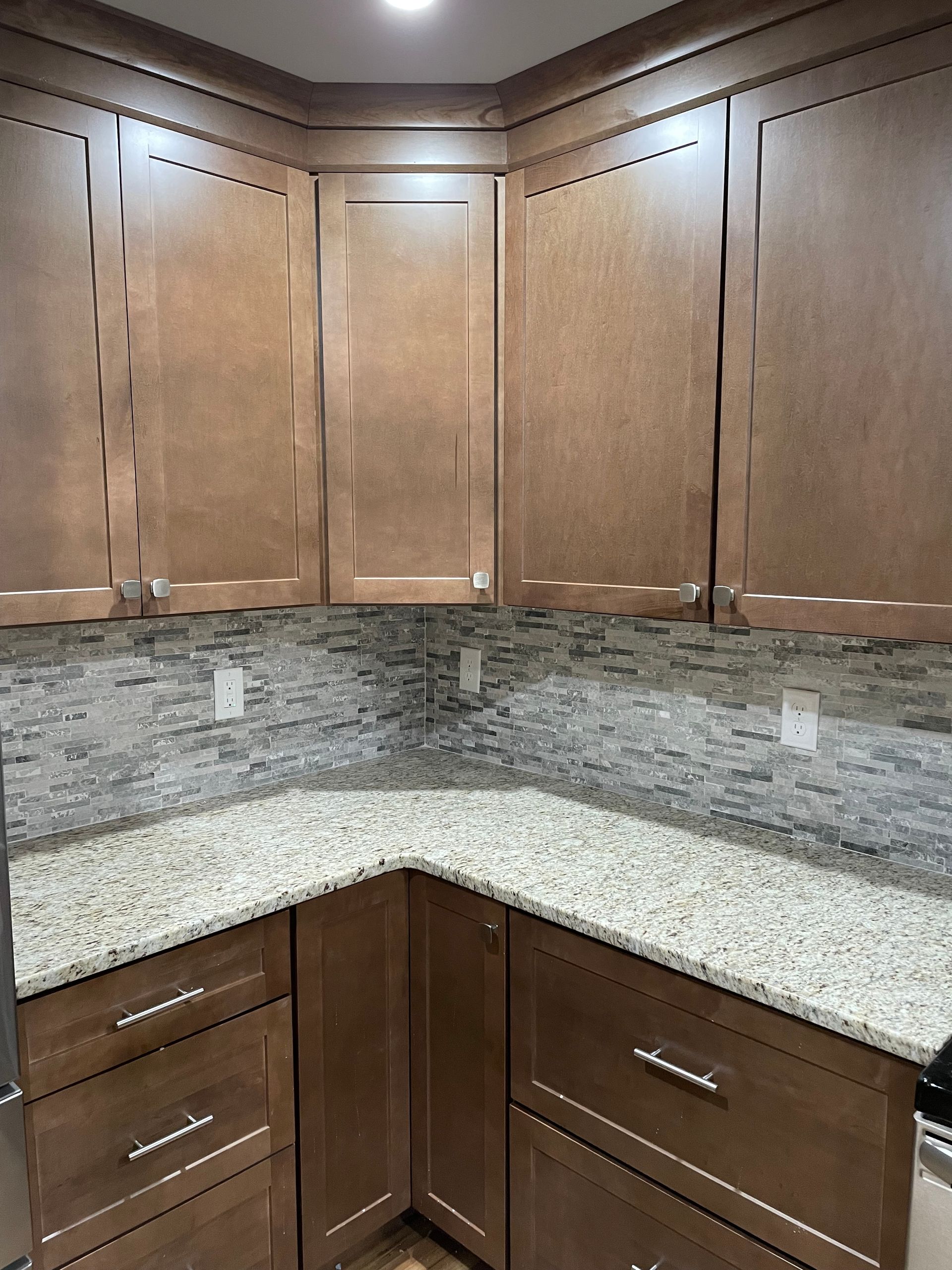 A kitchen with wooden cabinets and granite counter tops