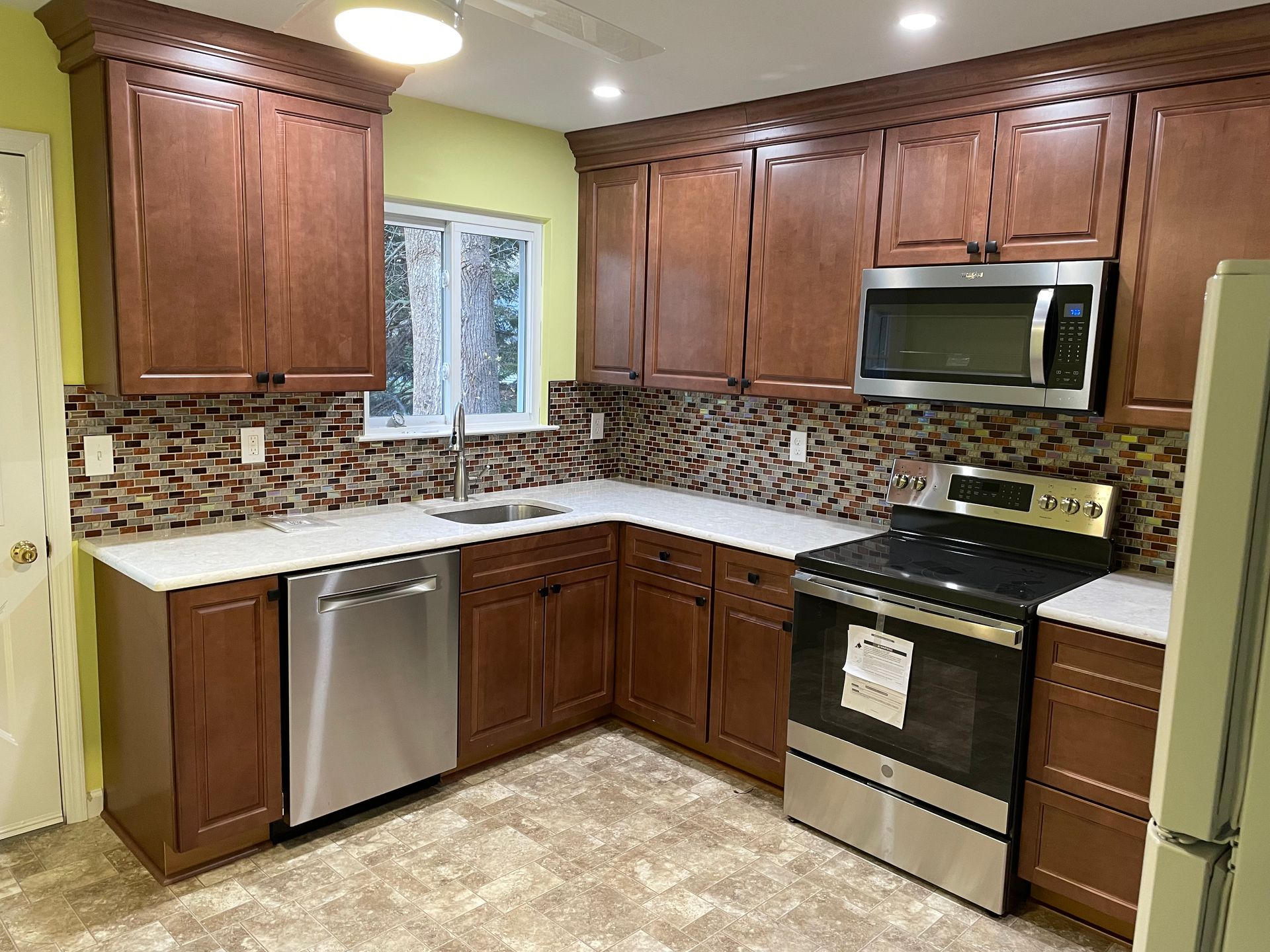 Kitchen with wood cabinets and yellow walls