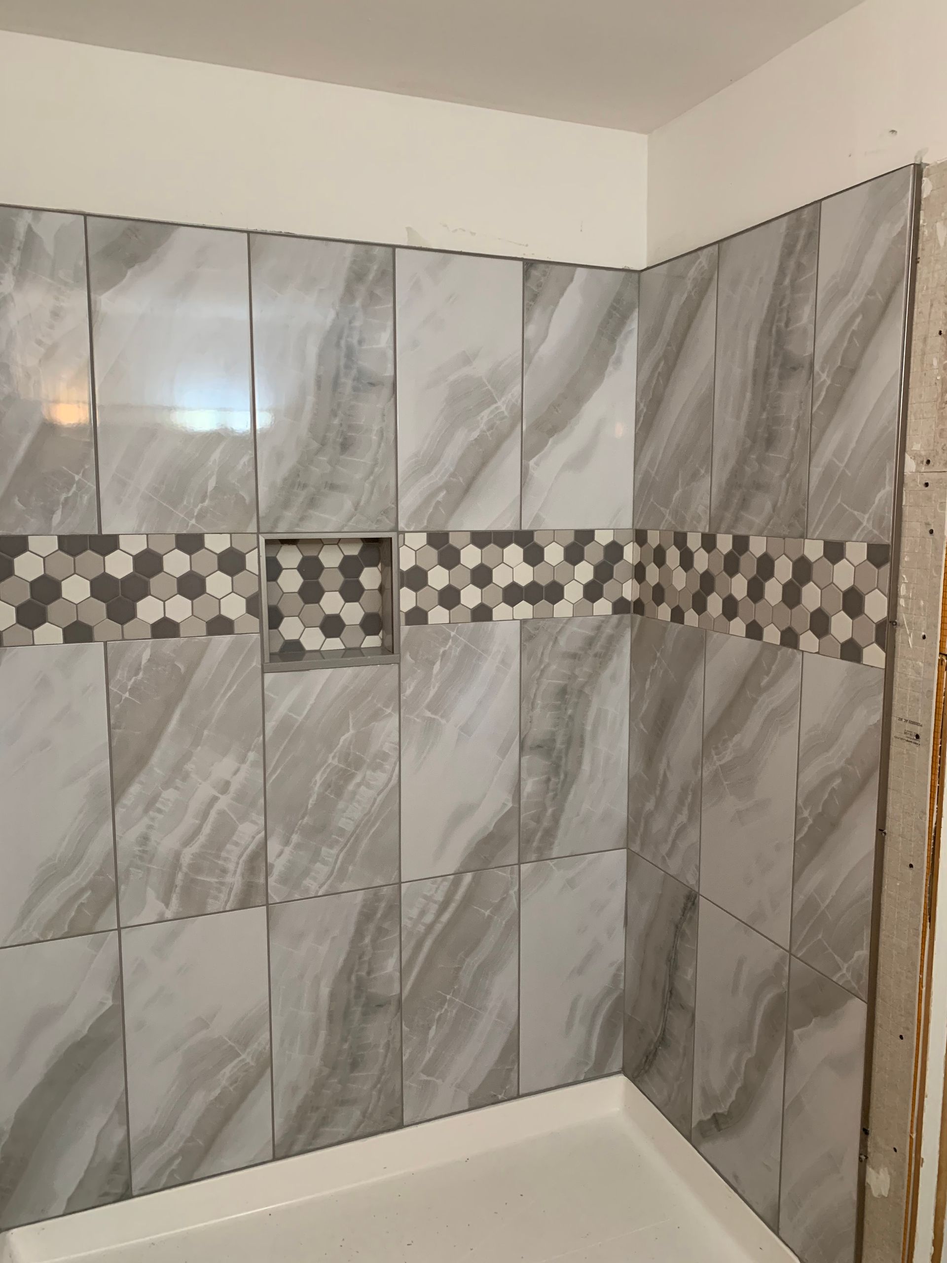 A shower with marble tiles