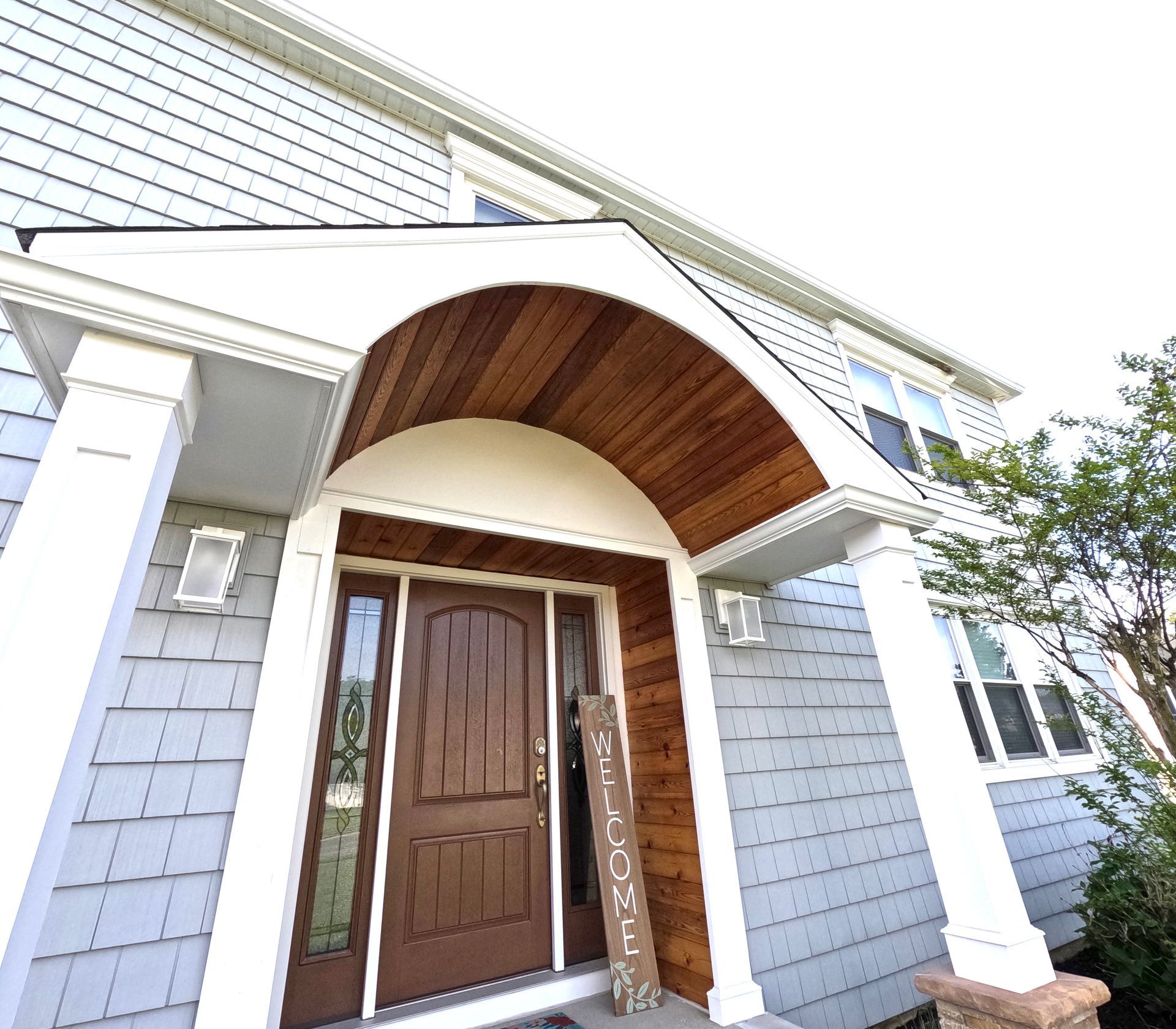 The front door of a house with a sign that says welcome