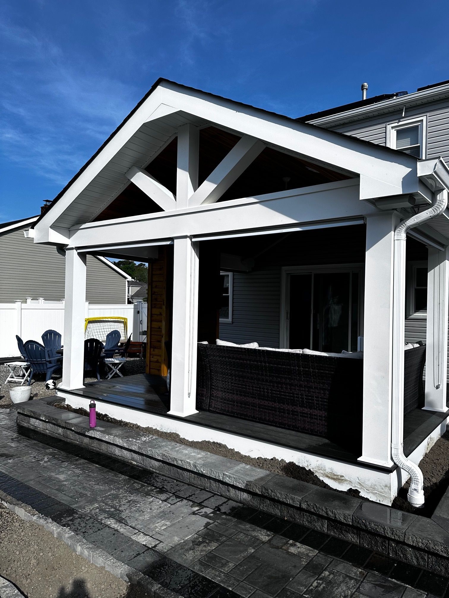 A house with a porch and stairs in front of it