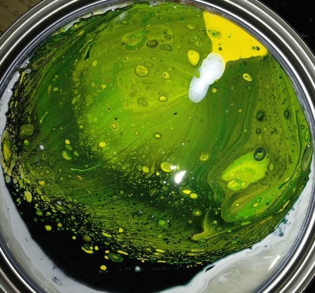 A close up of a green and yellow paint swirl