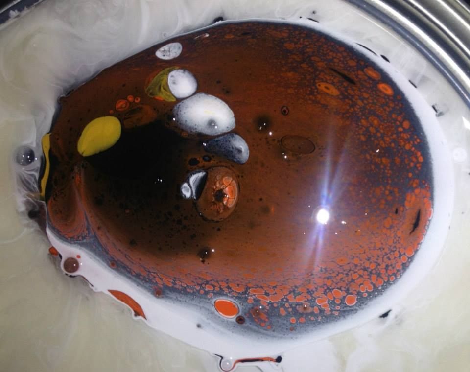 A close up of a brown and white liquid in a bowl.