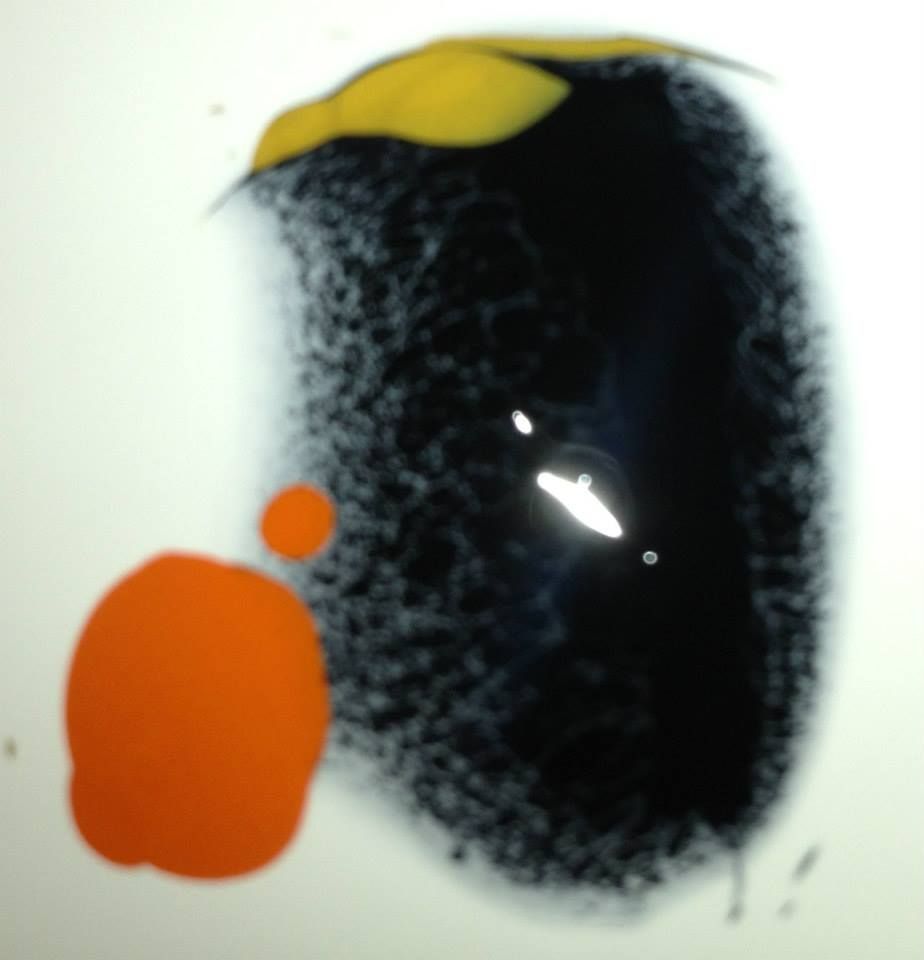 A close up of a black and orange circle on a white surface