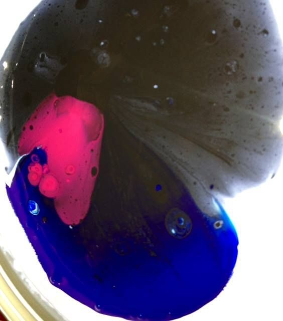 A close up of a blue and pink liquid
