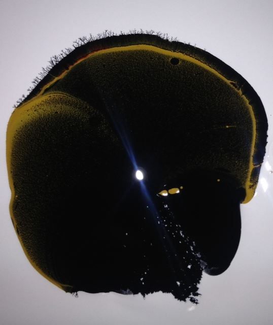 A close up of a black and yellow circle on a white surface