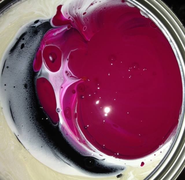 A close up of a can of purple paint