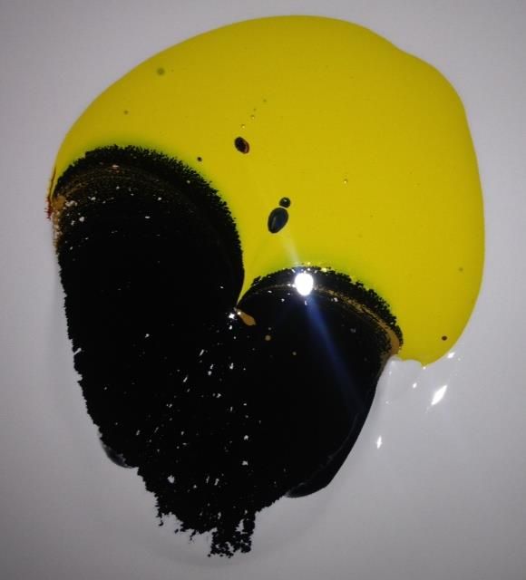 A yellow and black circle on a white surface