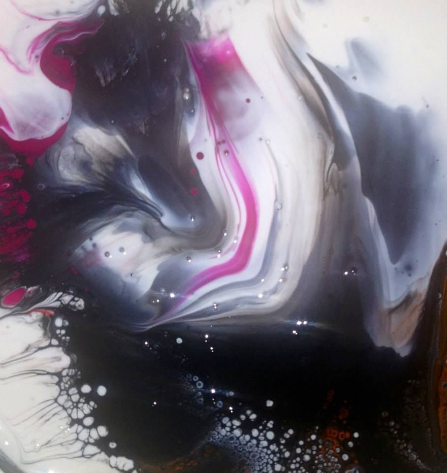 A close up of a painting with black white and pink colors
