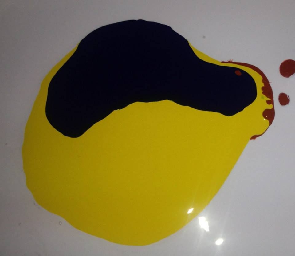 A yellow and black circle on a white surface