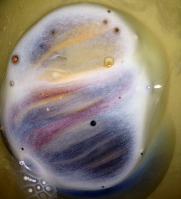 A close up of a sphere with a purple swirl on it