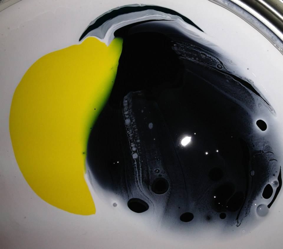 A yellow and black circle on a white surface