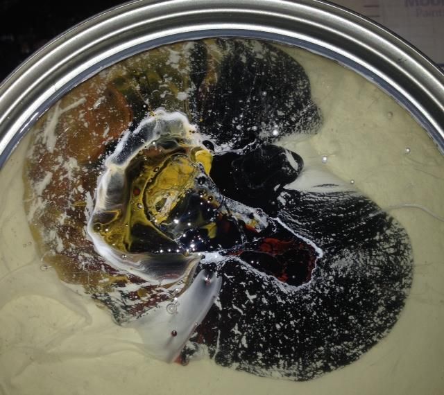 A close up of a can of paint that looks like a brain