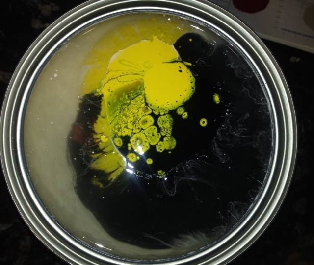 A bowl with yellow and black liquid in it