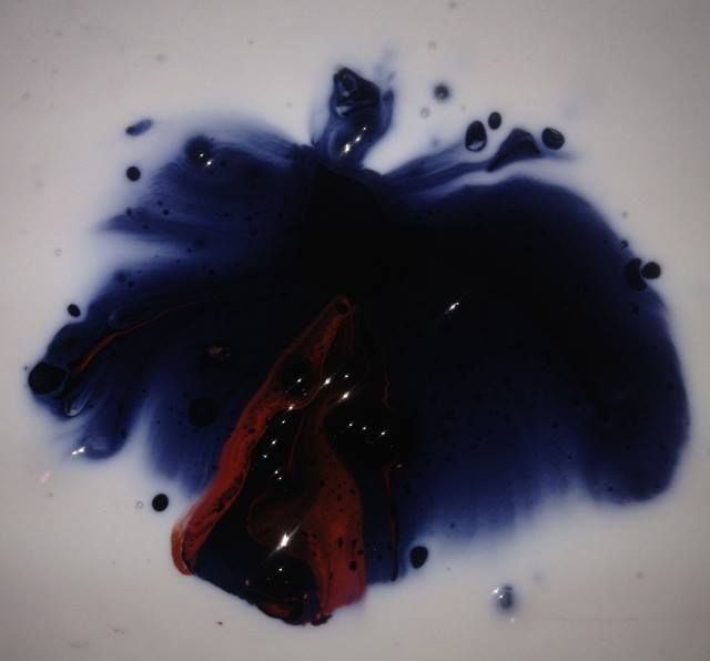 A large amount of blue and red liquid on a white surface