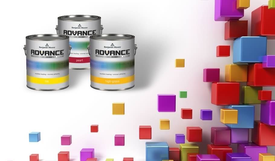 Three cans of advance paint next to a wall of colorful cubes