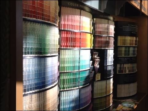 A display of different colored paint swatches in a store