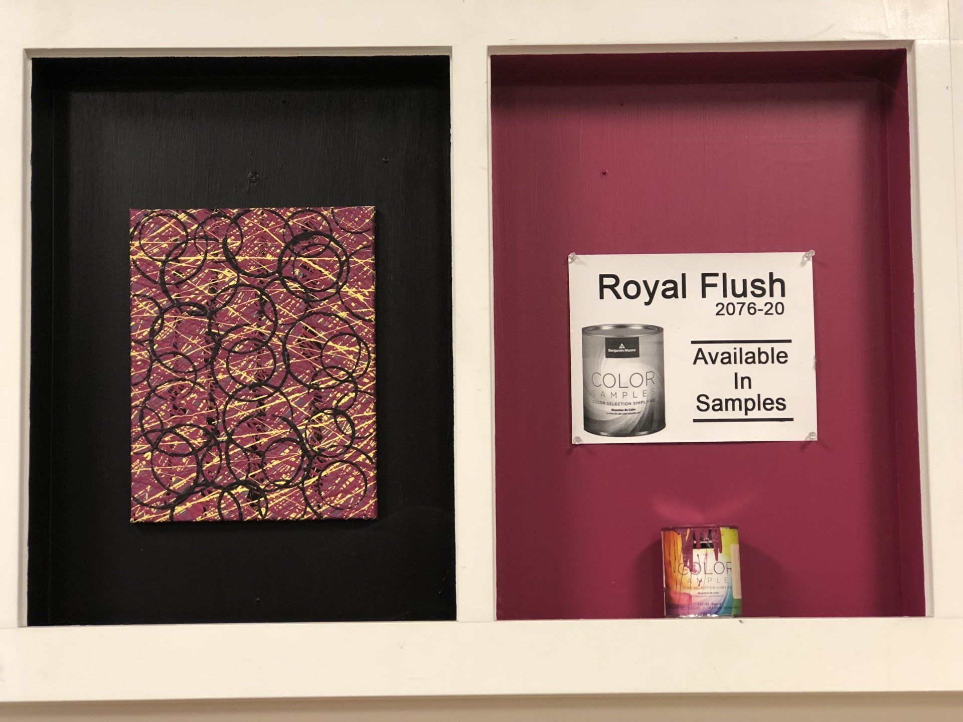 A framed picture of a royal flush candle in a display case.
