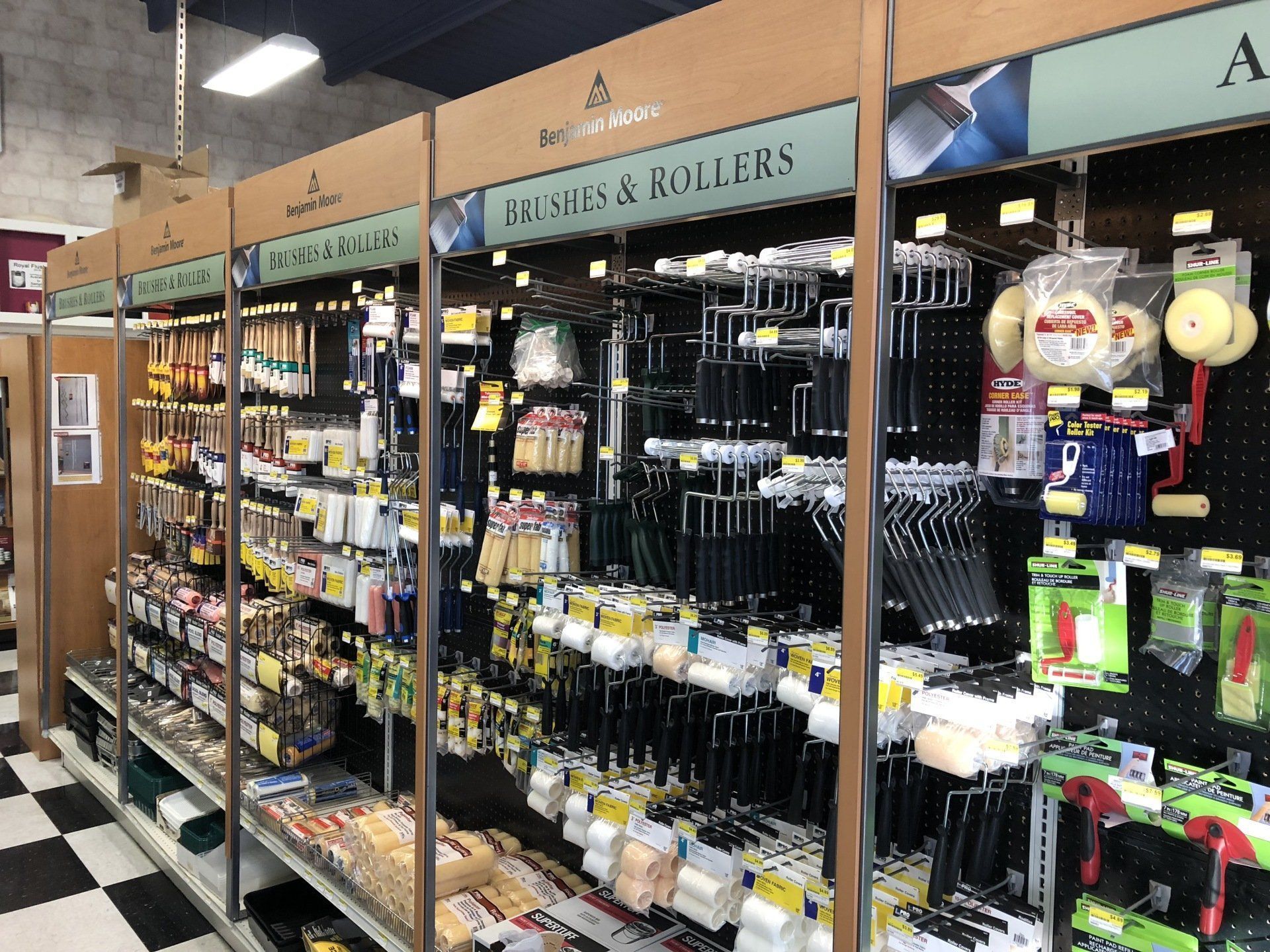 A display of brushes and rollers in a hardware store